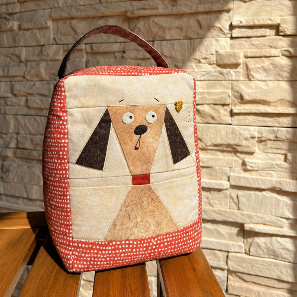 Finished Doggy on Duty geometric dog door stopper on wooden bench in sunlight against stone wall